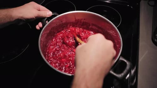 Overhead Shot of Person Stirring Food in Pot