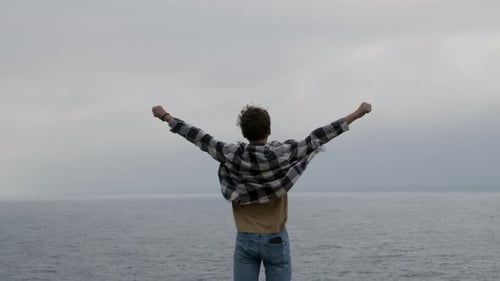 Teenager with Open Arms By the Sea