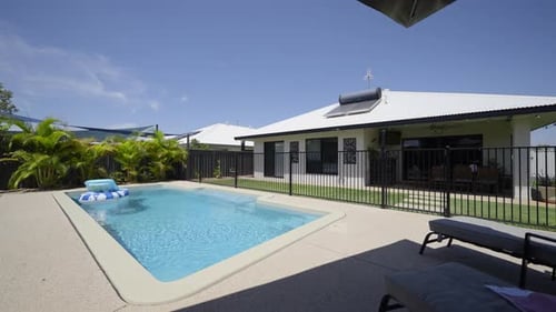 Outdoor entertainment area, luxurious contemporary outdoor swimming pool in ground concrete decking,