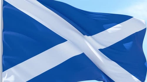 Scotland National Flag Waving Against Blue Sky