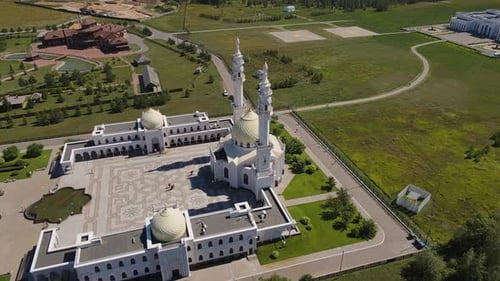 An Aerial View Shows the Beauty of the White Mosque Surrounded By Lush Greenery
