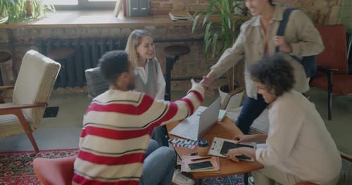 Diverse Group of Businesspeople Meeting in Creative Office Shaking Hands Talking Discussing