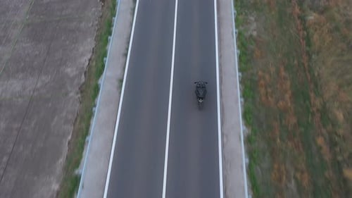 Top View to Motorcyclist Racing His Motorcycle on Country Road