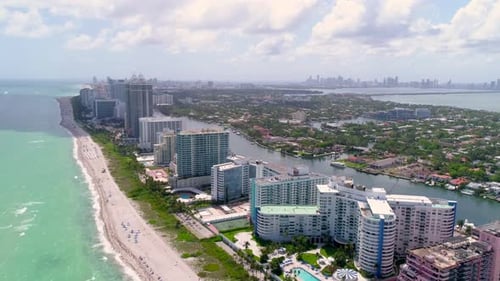 Miami beach flyover aerial drone view of turquoise water and white sand in Florida