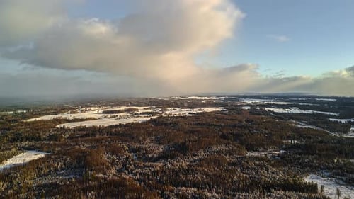 Snowy winter landscape from above, wide scenic aerial view of countryside fields