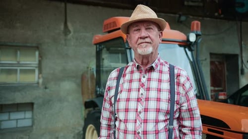 Portrait of Bearded Middleaged Man Looking at Camera in Farm Serious Agricultural Worker Standing in