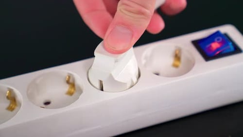 Hand Plugs White Plug into Extension Cord