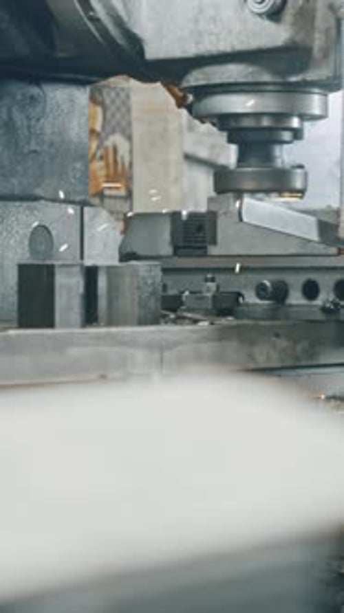 Precision metal cutting machine in action, creating sparks
