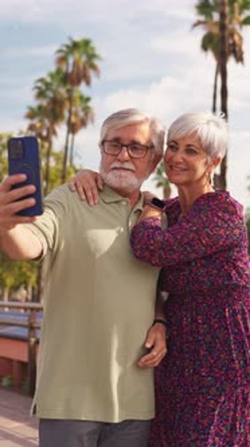 Senior Couple Taking Selfie Together Outside in Park