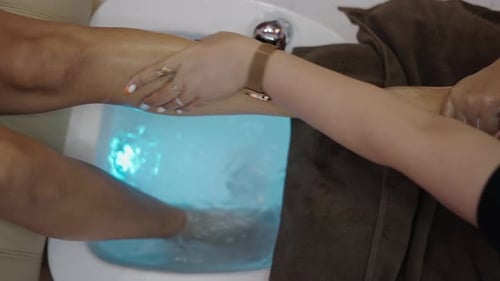 From Above Close Up Shot of Pedicure Professional Hands Spreading Cream Shower to a Client