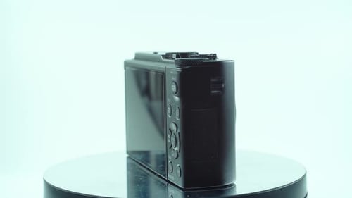 Close up shot of a small black pocket camera, aluminiaum built, function buttons, studio lighting, s