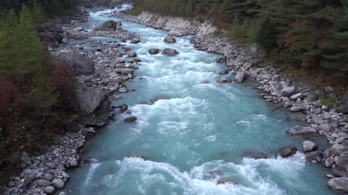 A high angle view of a river flowing with glacial water in the Himalaya Mountains of Nepal.