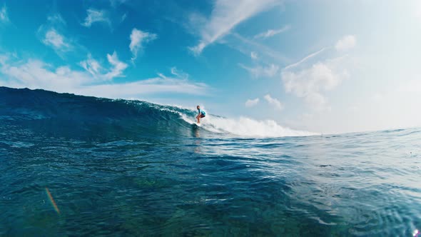 Professional surfer rides the wave and tries to get barrelled, People ...