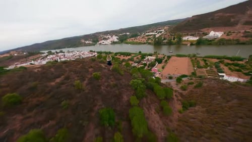 FPV Drone Shot Following Man Going Down on Zip Line and Crossing the River Spain