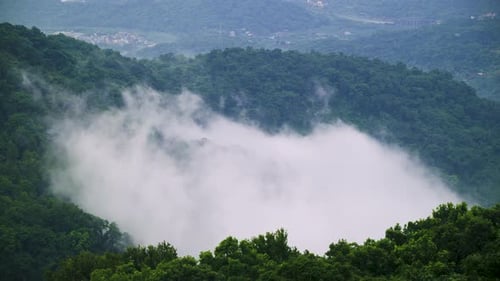Clouds Drifting Over Lush Green Hills.