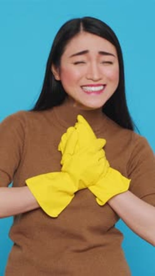 Young Woman with Cleaning Gloves Smiling Proudly