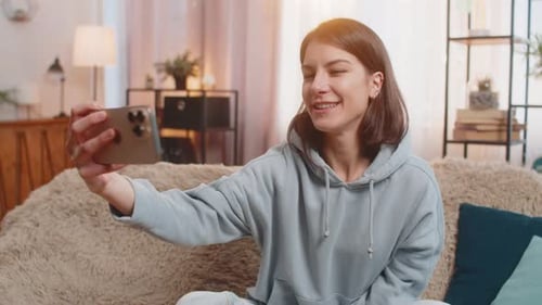 Smiling Young Woman Video Calling on Mobile Phone