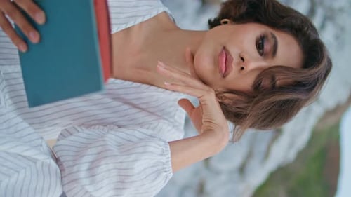 Coast Girl Enjoying Book on Cloudy Day Vertical Closeup Focused Woman Relaxing