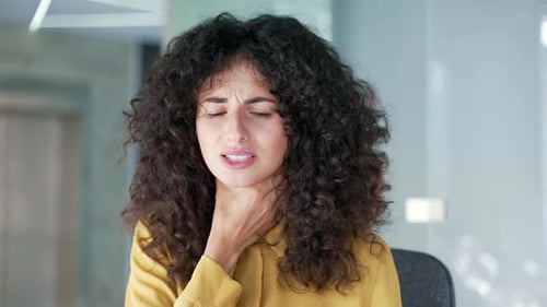 Woman in Office Suffering From Sore Throat