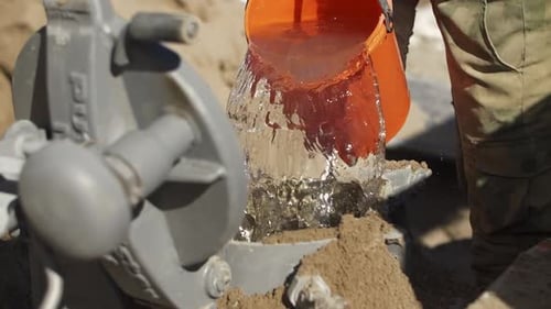 Pouring Water Into Mixer for Construction