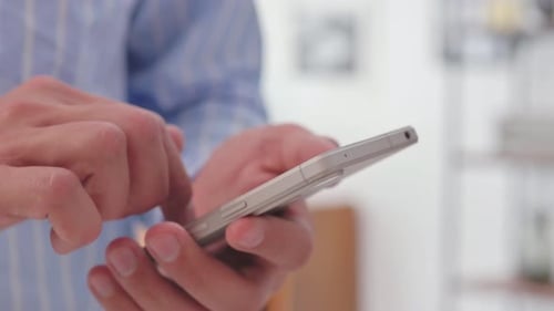 Hand Browsing Internet on Smartphone