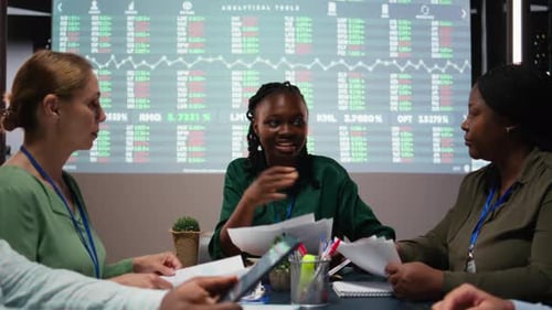 Diverse Team Analyzes Market Data in Office Meeting