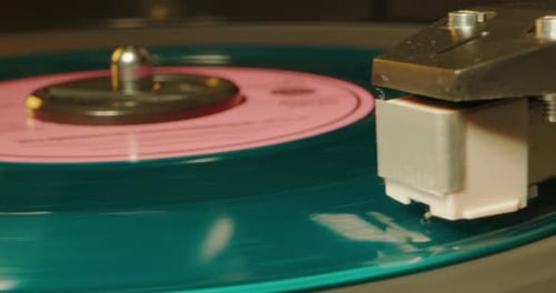 Teal Vinyl Record Spinning on Record Player