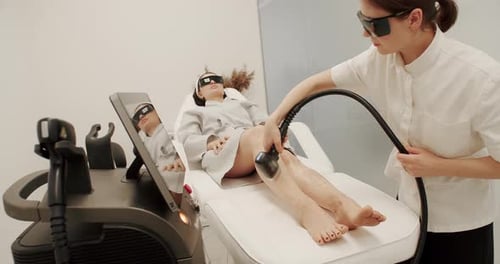 Woman Receiving Laser Hair Removal Treatment on Legs