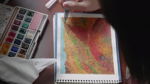 Artist Paints On Sketchpad Using A Watercolor Brush Pen. - high angle