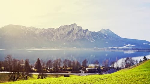 Tranquil Lake in Mountains with Village