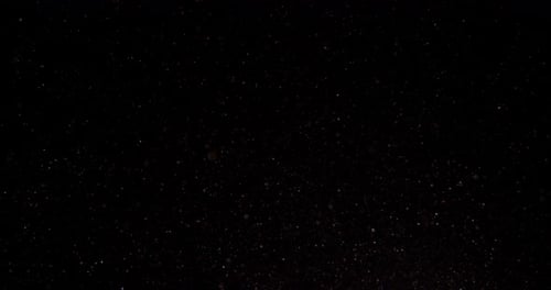 Cinematic Purple Dust Particles Floating on Black Background in Slow Motion