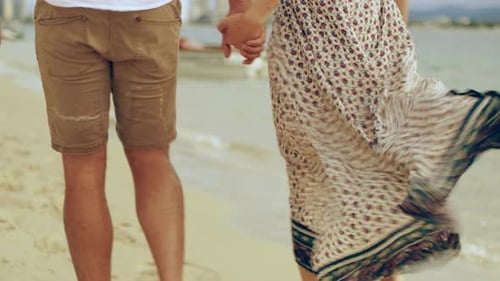 Young Couple Walking Near the Shore Along the Beach in Australia With