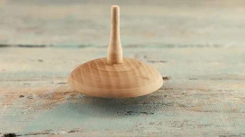 Hypnotic Spinning Wooden Top on Painted Surface