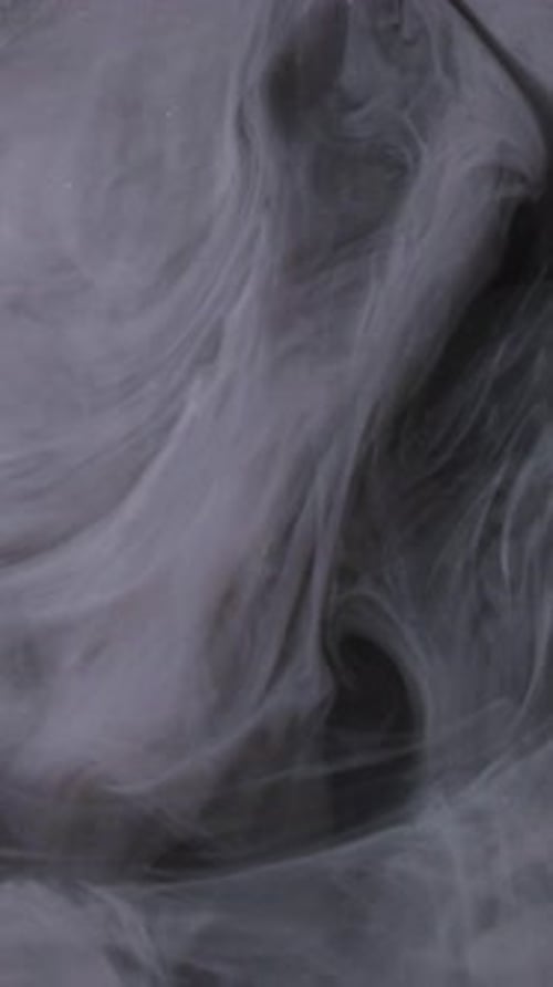 Fluid White and Gray Paint Swirling Abstractly