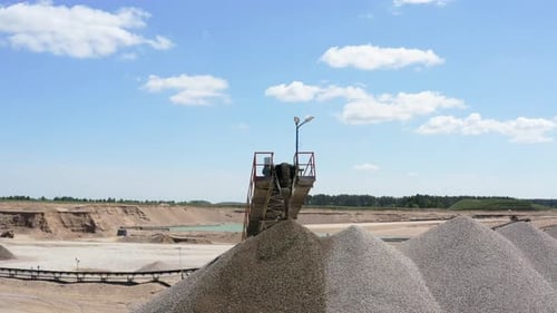 Closeup Of Conveyor Belt At Work At Gravel Processing Plant In Quarry Site. orbiting drone shot