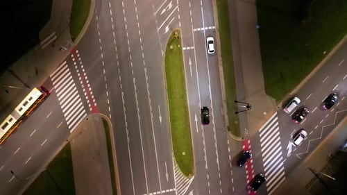 Car traffic transport on crossing multiple lanes highway or expressway in at night, drone aerial top