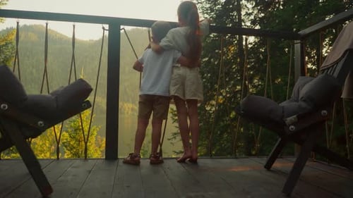 Children Embracing Overlooking Mountain Lake at Sunrise