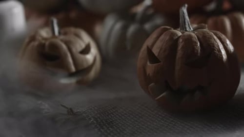 Spooky Carved Pumpkins Displayed in a Foggy Scene
