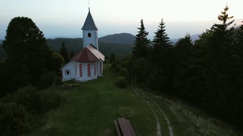 This is an aerial video of a beautiful and lonely church in the Slovenian landscape, filmed during a