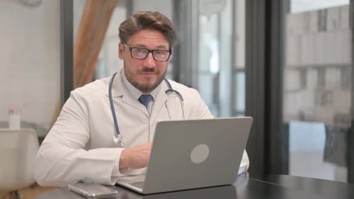 Young Doctor Smiling at Camera in Clinic