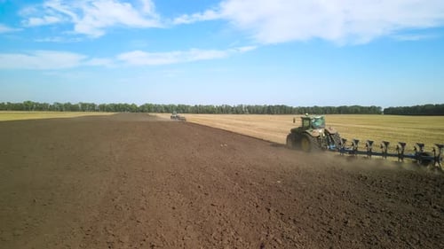Tractors plowing the field in Ukraine