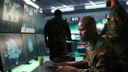 Man in Military Uniform Working at Computer