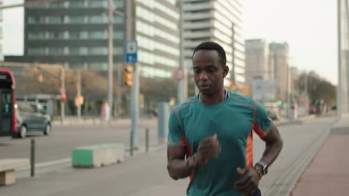 Young African American Man Athlete Running in the City Training for Sport Race