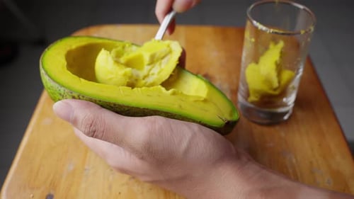 Scoop creamy, green fruit away from skin, smooth texture, avocado flesh
