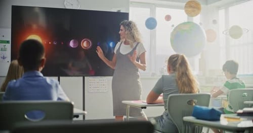Astronomy Class Female Teacher Explaining Solar System to Primary School Children Using Digital