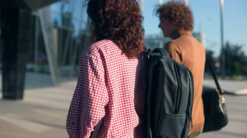 Rear View of Young Male and Female Classmates Walking on Campus Together