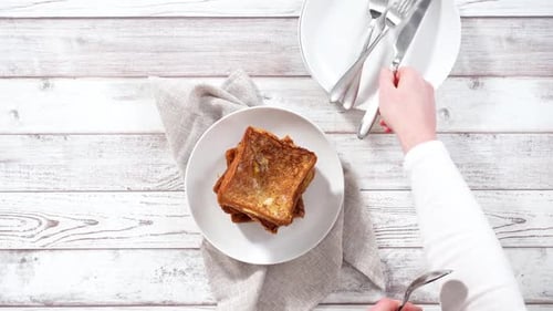 Step By Step Garnishing Stack of Freshly Made French Toast with Mix Berry Compote and Powder Sugar