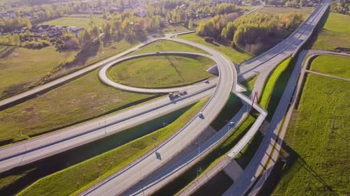 Slow drone orbit around Katlakalns A5 Riga bypass interchange showing loop ramp and bridge