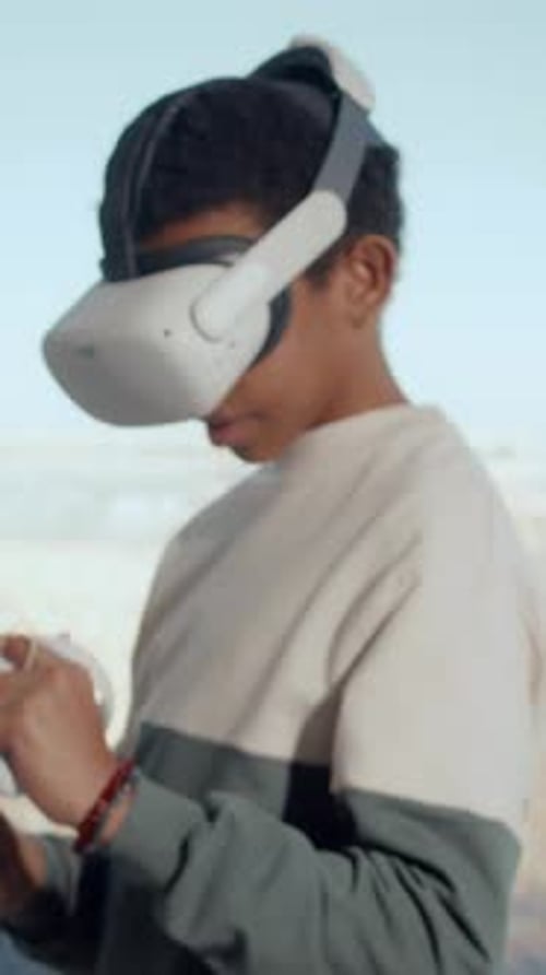 Boy uses VR Headset in Urban Environment