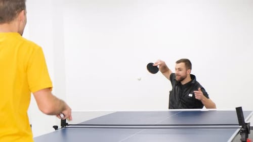 A Man in a Wheelchair Plays Table Tennis Sports Excitement Games with a Racket